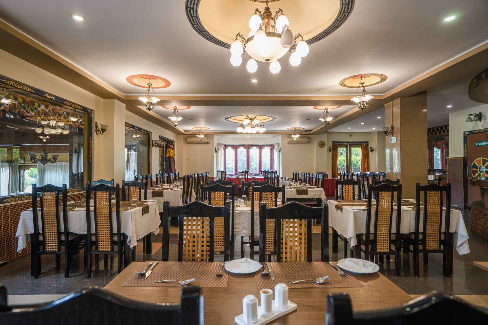 Outdoor terrace dining with mountain views at Hotel Migmar